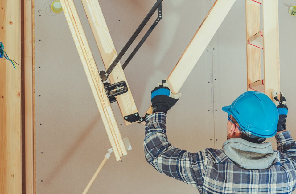 man assembling loft conversion ladder